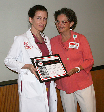 Beth Higgins receives Employee of the Month from Dr. Kate Heilpern, SVP and COO of NewYork-Presbyterian/Weill Cornell