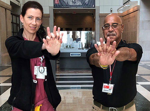 Beth Higgins and her CPR instructor, Larry Wheeler, show off their hands-only CPR form
