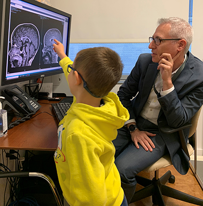 Dr Greenfield with his young patient Harvey