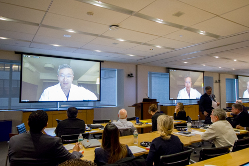 Dr. Walter Jean addresses attendees from Vietnam via webcam
