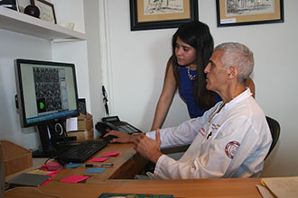 Dr. Mark Souweidane reviews MRI scans of DIPG tumors with Fatima Nathalia Morales