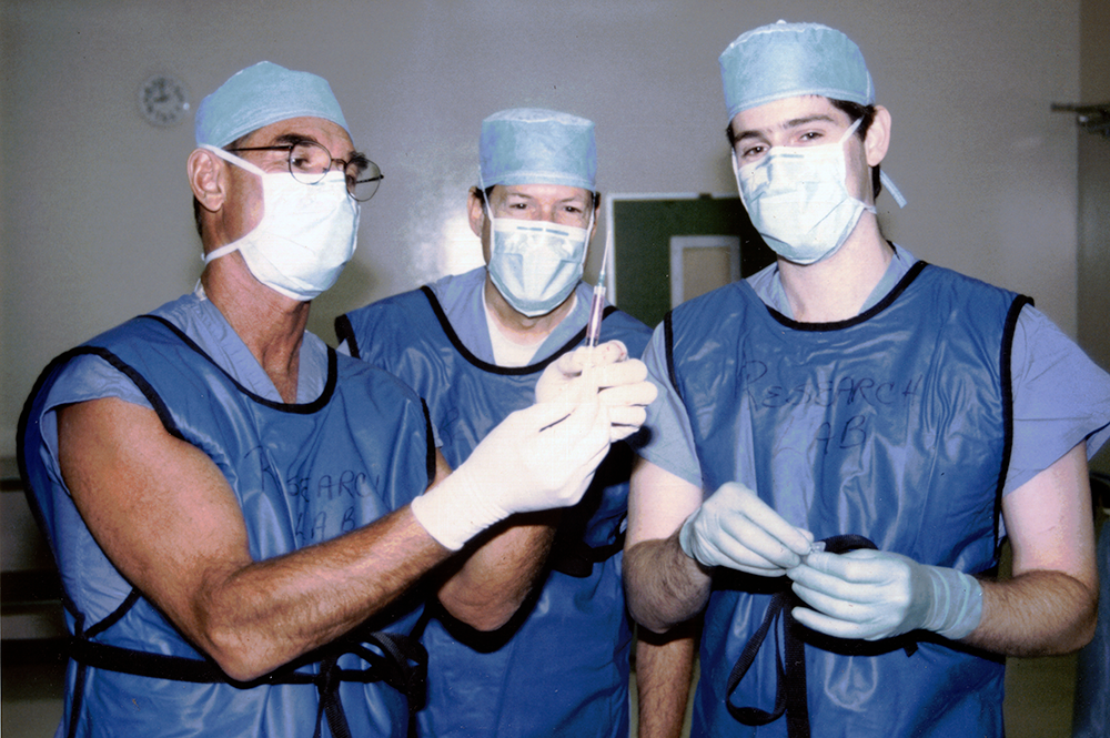 1995: Heart surgeons Dr. Edward (Ted) Dietrich (left) and Dr. Martin J. Kaplitt (center) work with Dr. Michael Kaplitt (at the time an intern at Weill Cornell) testing gene therapy