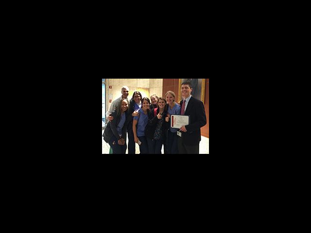 Dr. Mark Souweidane (far left) and the PICU staff congratulate Dr. Benjamin Rapoport on his award