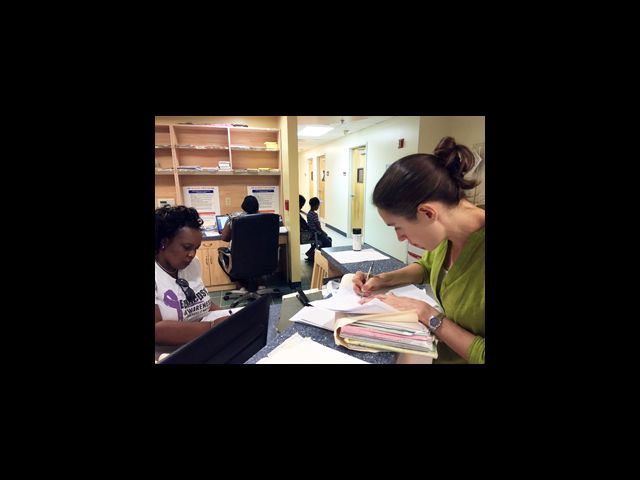 Dr. Hoffman updates a patient chart during her mission trip to Antigua