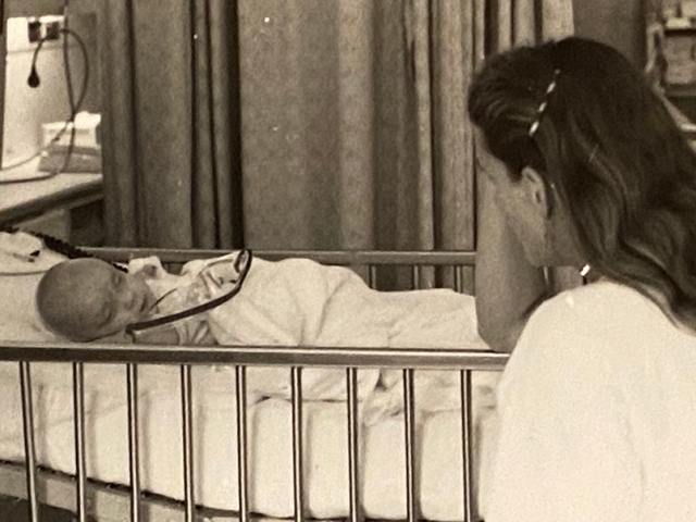 Will Clarkson as a baby, with his mother at his bedside before craniosynostosis surgery