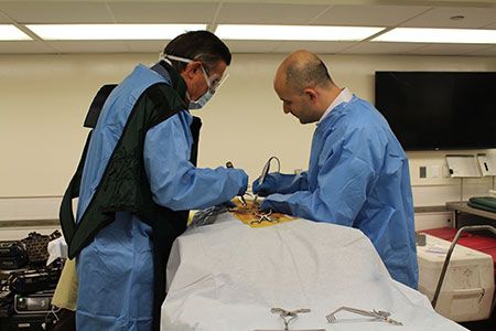 Dr. Ali Baaj (right) in the lab at the Complex Spine CME