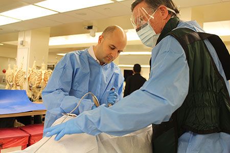 Dr. Ali Baaj (left) in the lab at the Complex Spine CME