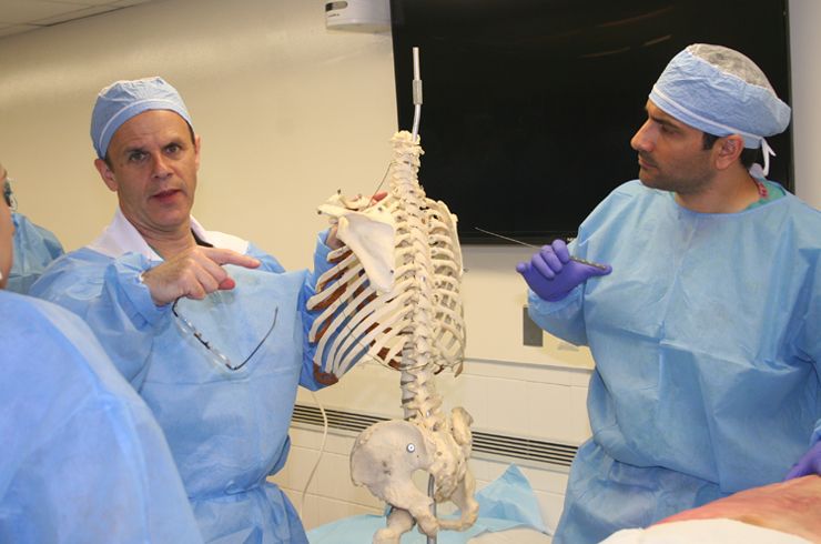 Sixth-year Weill Cornell resident Michael Virk (right) assists Dr.Mark Bilsky of MSKCC at a spine station