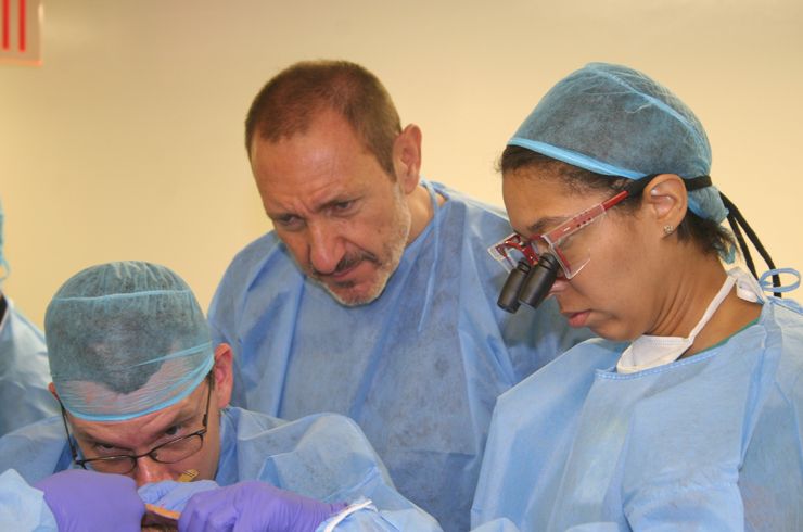 Dr. Bernardo (center) oversees students at a skull base station