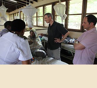 Dr. Greenfield confers with families of young patients