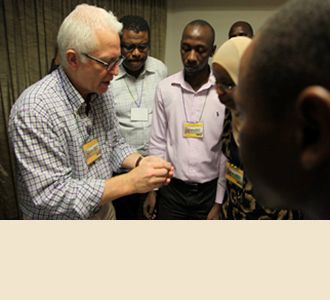 Dr. Stieg demonstrates the use of a drill during hands-on training.