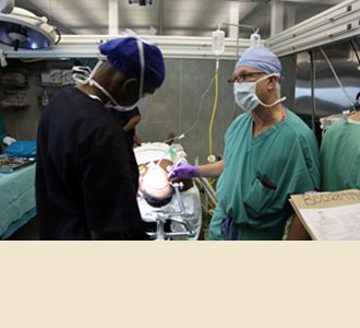 Dr. Stieg instructs a resident during aneurysm surgery at Muhimbili Hospital.