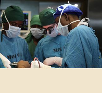 Dr. Greenfield, with Tanzanian residents, attends to a patient in the operating room.