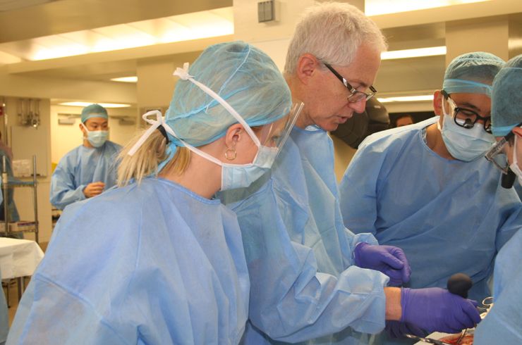 Dr. Elowitz guides residents in a spine surgery technique