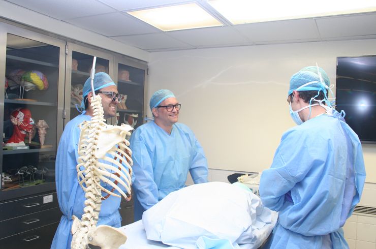Dr. Hartl prepares for hands-on spinal dissection