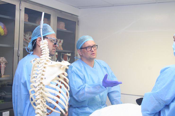 Dr. Hartl talks to his students before hands-on spinal dissection